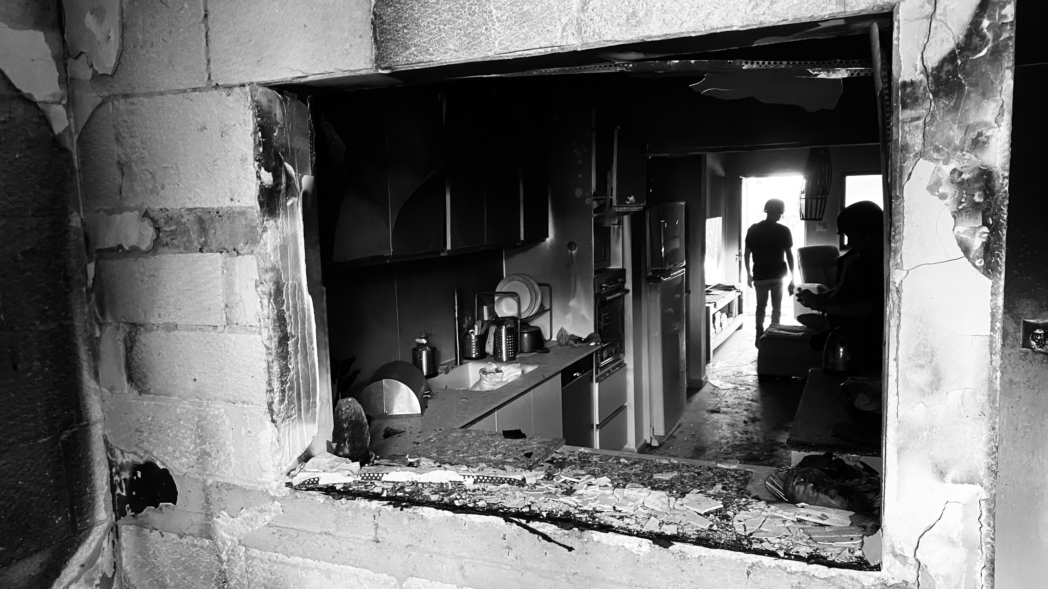 Reporters inspect a damaged home in Holit, Israel on Oct. 26.