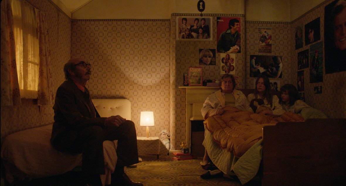 Christopher Ettridge as Maurice Grosse, Paula Benson as Peggy Hodgson, Charlotte Miller as Margaret Hodgson and Olivia Booth-Ford as Janet Hodgson in 'The Enfield Poltergeist,' premiering October 27, 2023 on Apple TV+.