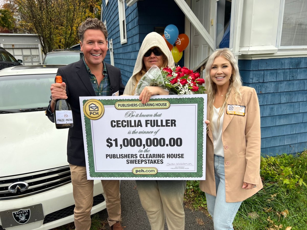 Publishers Clearing House Sweepstakes winner Cecilia Fuller poses with members of the prize patrol team, who were eventually able to coax her out of her Syracuse, N.Y. home.