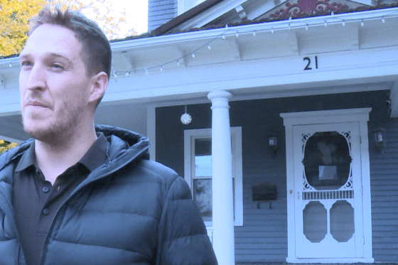 Shawn Arseneault stands in front of his downt.own Moncton home