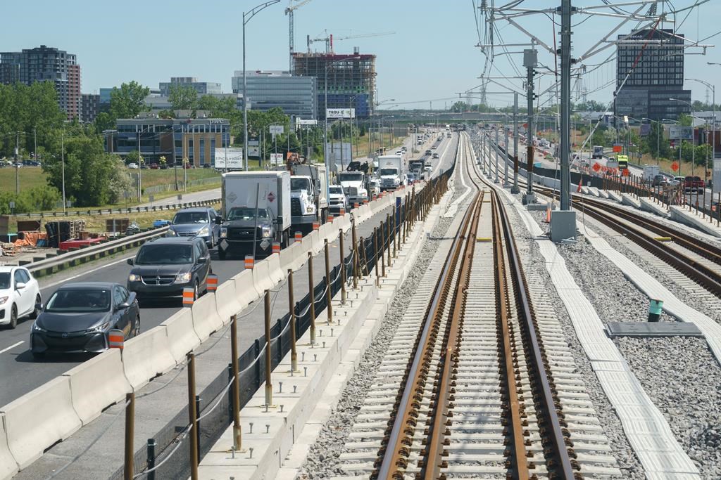 A Montreal suburb will have to pay thousands of dollars in compensation to around 300 residents who say they've suffered from years of unreasonable traffic noise, a Quebec Superior Court judge has ruled. Traffic is seen on a road as a train rolls along the track in between lanes of a freeway during a media tour of the Reseau express metropolitain (REM) in Brossard, Que. on Thursday, June 10, 2021. THE CANADIAN PRESS/Paul Chiasson.