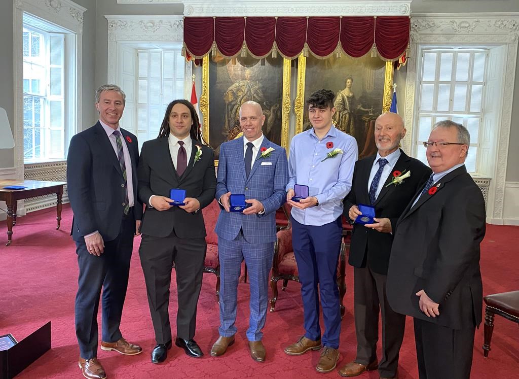 Nova Scotia Premier Tim Houston, left to right, with Nova Scotia Medal of Bravery recipients Talbot Boyer, Scott Buchanan, Adam Lefort, Robert McGregor and medal committee chair Tom Steele at the provincial legislature on Wednesday, Nov. 8, 2023.
THE CANADIAN PRESS/Keith Doucette .