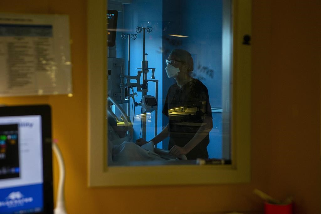 Ontario's patient ombudsman says his office has seen a 33 per cent increase in complaints, and noted a "troubling" trend about problems accessing primary care. A nurse tends to a patient in the intensive care unit at the Bluewater Health Hospital in Sarnia, Ont., on Wednesday, January 26, 2022.