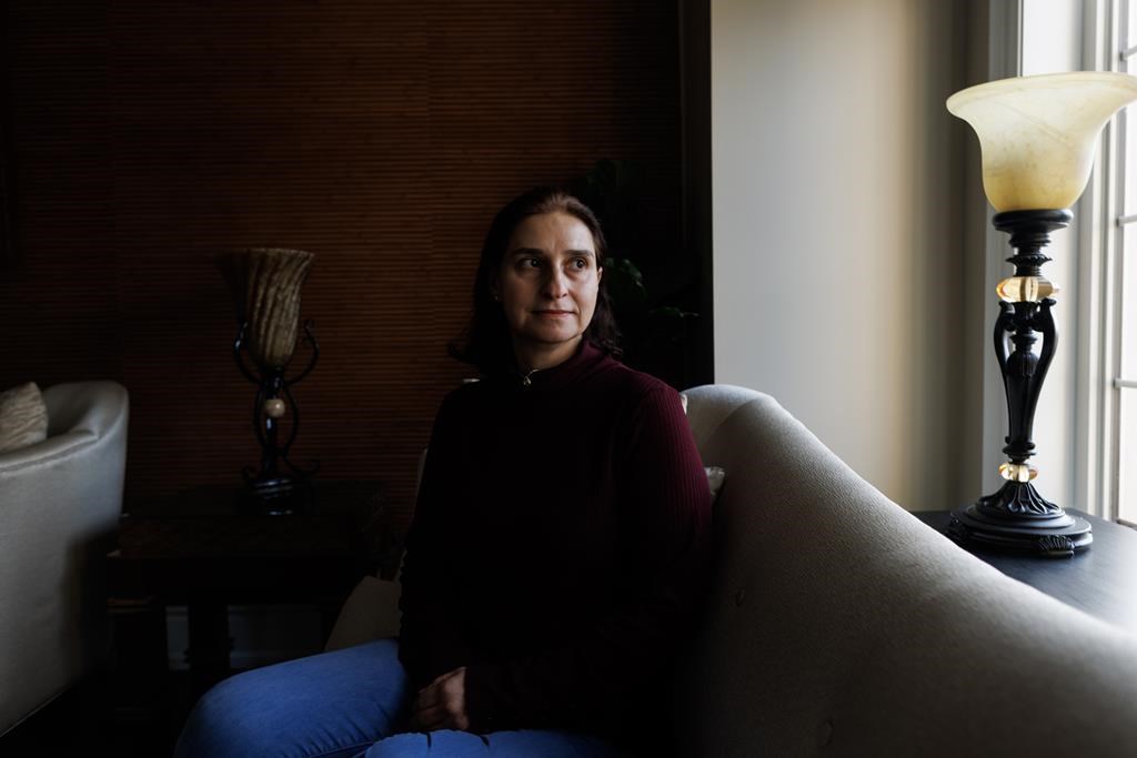 Rana Nassrawi sits in her home in Mississauga, Ont., Thursday, Nov. 16, 2023. Nassrawi is finally home from a harrowing journey after a trip to visit family in Gaza with her two youngest sons was interrupted by the outbreak of war.