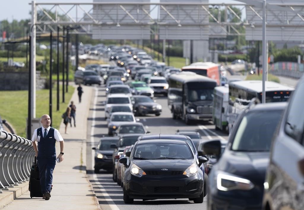 <div>The authority overseeing the Montreal airport is announcing measures to reduce congestion after a post-pandemic surge in car traffic over the summer prompted a wave of frustration among passengers trying to make their gate on time. A WestJet cabin crew member walks past traffic to make his flight at the Pierre Elliott Trudeau airport, in Montreal, Thursday, Sept. 7, 2023. THE CANADIAN PRESS/Christinne Muschi</div>.