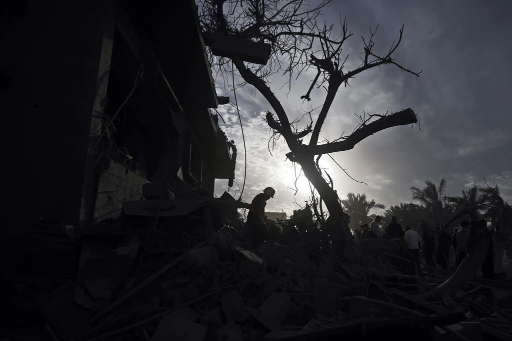 Palestinians inspect the damage of a destroyed house following Israeli airstrikes in the town of Khan Younis, southern Gaza Strip, Wednesday, Nov. 22, 2023. A four-day truce announced Wednesday will free dozens of Israeli hostages held by militants as well as Palestinians imprisoned in Israel. It will also bring a large influx of aid to the besieged territory.THE CANADIAN PRESS/AP-Mohammed Dahman.