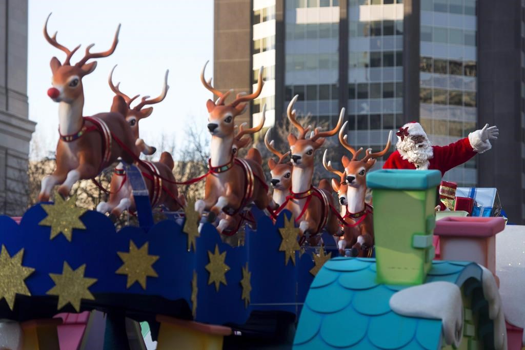 Santa Claus waves to the crowd from his float during the Santa Claus parade in Toronto on Sunday, Nov. 15, 2015. He will be back in the city again this Sunday for the annual downtown event. 