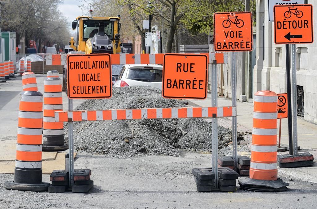 Construction cones are shown next to a construction site in Montreal, Tuesday, April 25, 2023. 