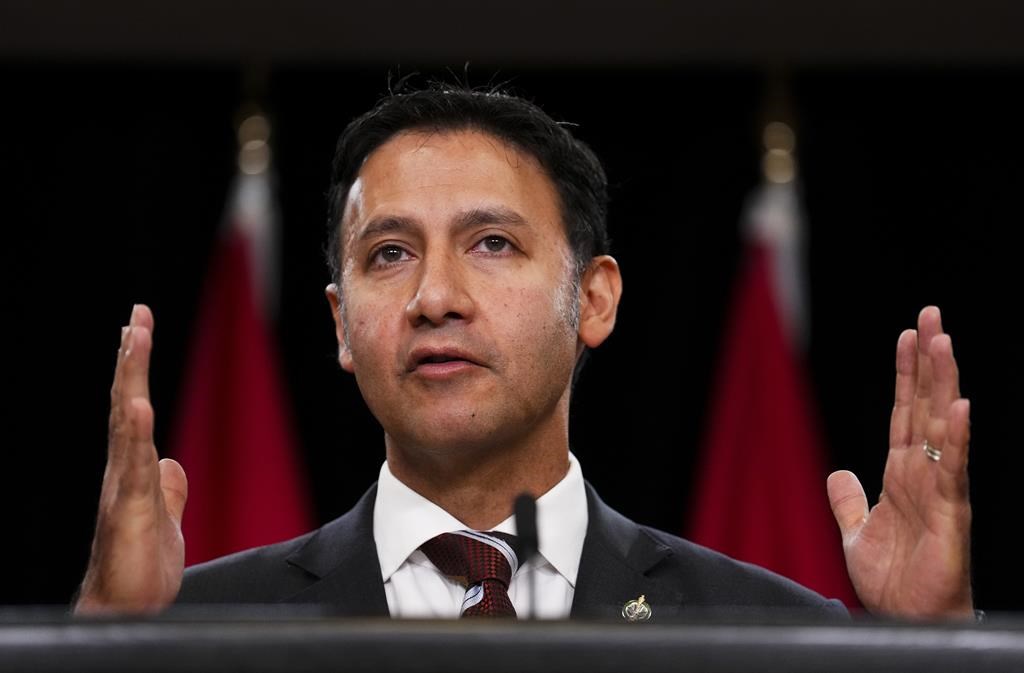 Federal Justice Minister Arif Virani holds a press conference at the National Press Theatre in Ottawa on Thursday, Oct. 5, 2023. Virani is "considering the options," raised by the independent adviser on unmarked graves, who says Indigenous leaders want Canada to move on criminalizing residential school denialism. 