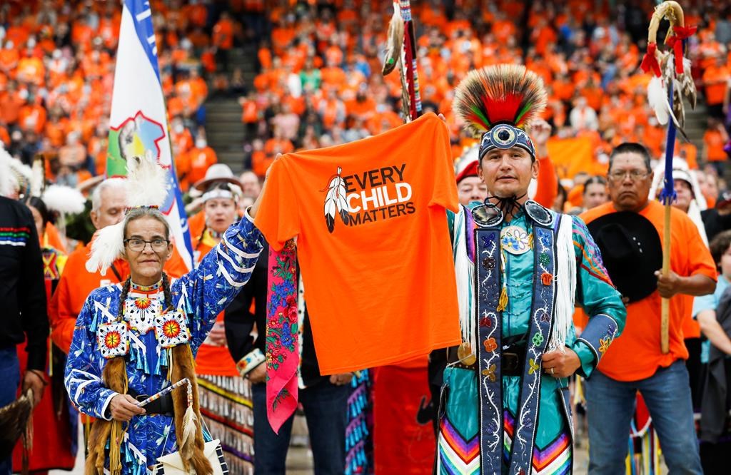 Sherry Starr and Wab Kinew lead the grand entrance at the second annual Orange Shirt Day Survivors Walk and Pow Wow in Winnipeg, Friday, Sept. 30, 2022.