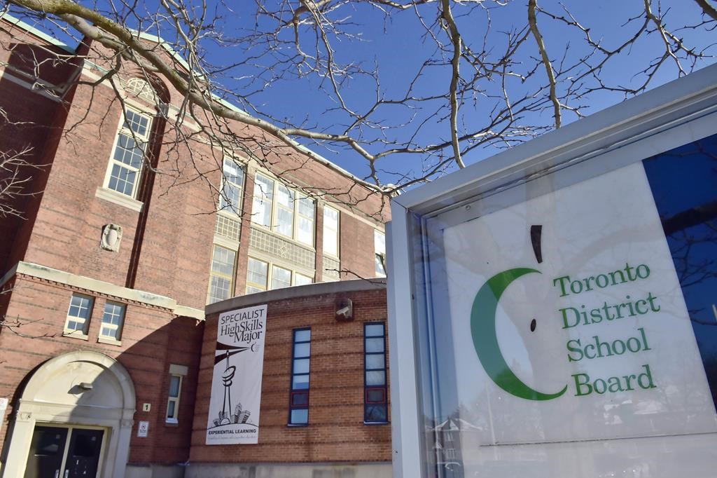 A Toronto District School Board logo is seen on a sign in front of a high school in Toronto, Tues., Jan. 30, 2018. Canada's largest school board says it has moved away from reporting every hate- or racism-related incident to school communities because letters about such incidents could lead to further harm. THE CANADIAN PRESS/Frank Gunn.