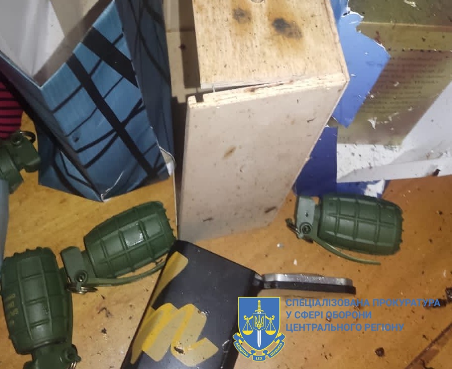 Photo of grenades and a gift bag lying on the floor, provided by the Special Prosecutor's Office of Ukraine's central division. On Nov. 6, 2023 a top Ukrainian army major died after setting off a grenade, gifted to him on his birthday, inside his home.