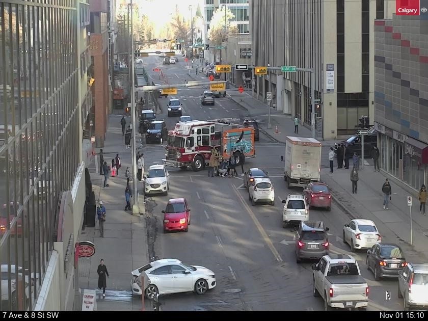 Emergency responders assist a pedestrian in downtown Calgary on Nov. 1, 2023.