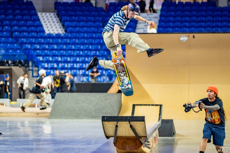A person does a trick on a skateboard