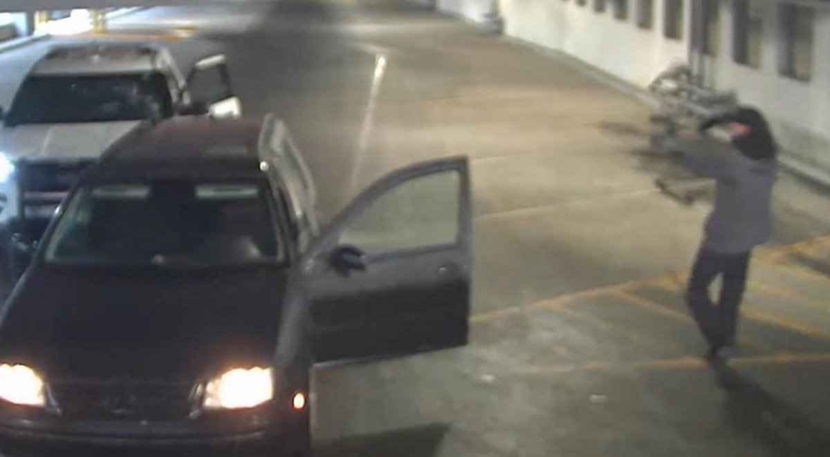 Security camera image of a man pointing a bow and arrow at a Red Deer RCMP officer in the hospital parkade on May 24, 2021.