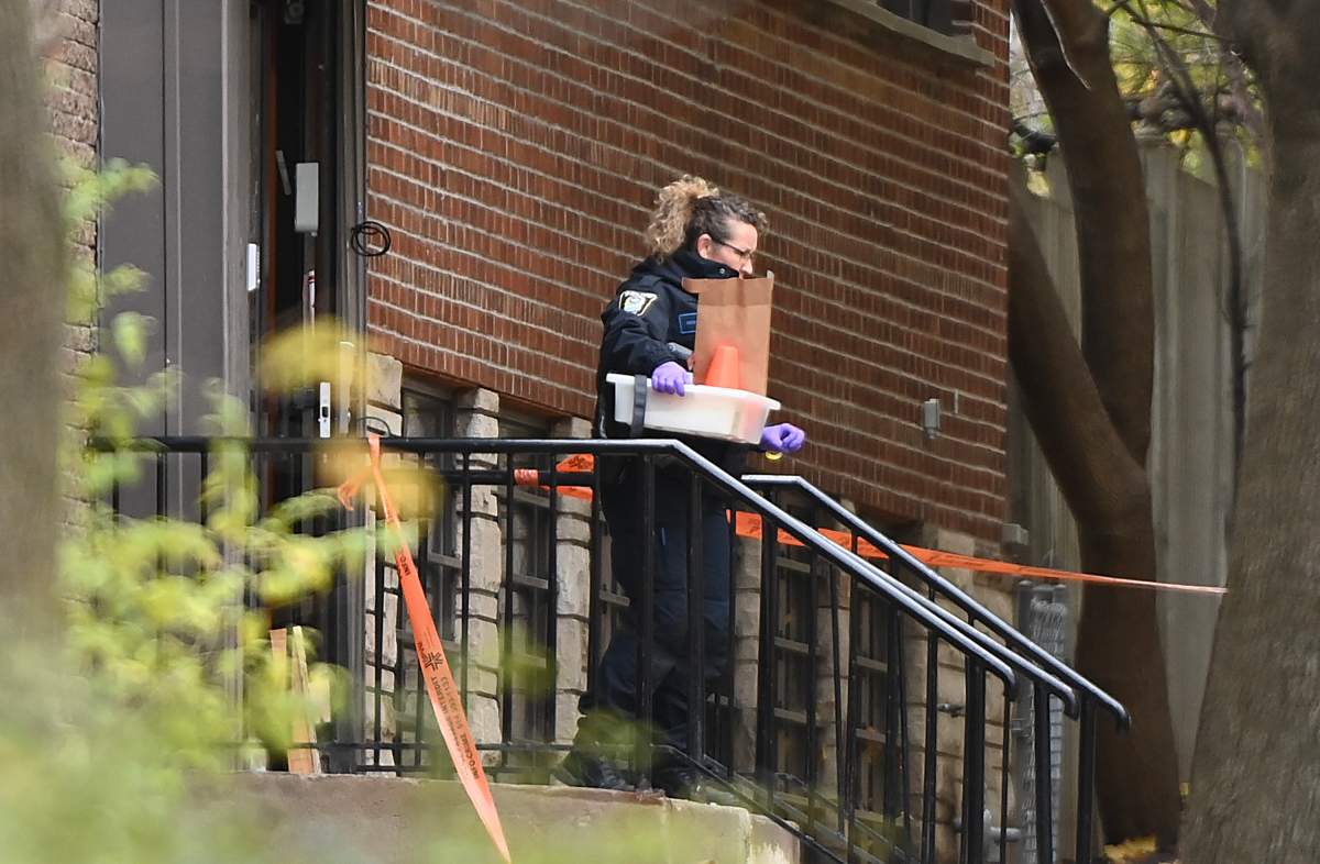A police officer exits the Yeshiva Gedolah Jewish school after shots were fired at the school in Montreal, Sunday, Nov. 12, 2023.