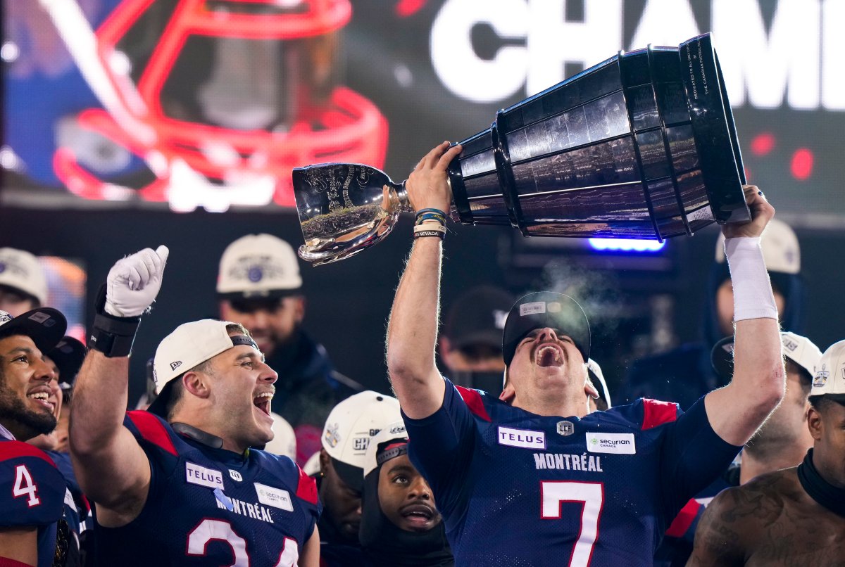 Montreal Alouettes quarterback Cody Fajardo (7) hoists the Grey Cup as fullback Alexandre Gagne (34) looks on as the Alouettes celebrate defeating the Winnipeg Blue Bombers in the 110th CFL Grey Cup in Hamilton, Ont., on Sunday, November 19, 2023.