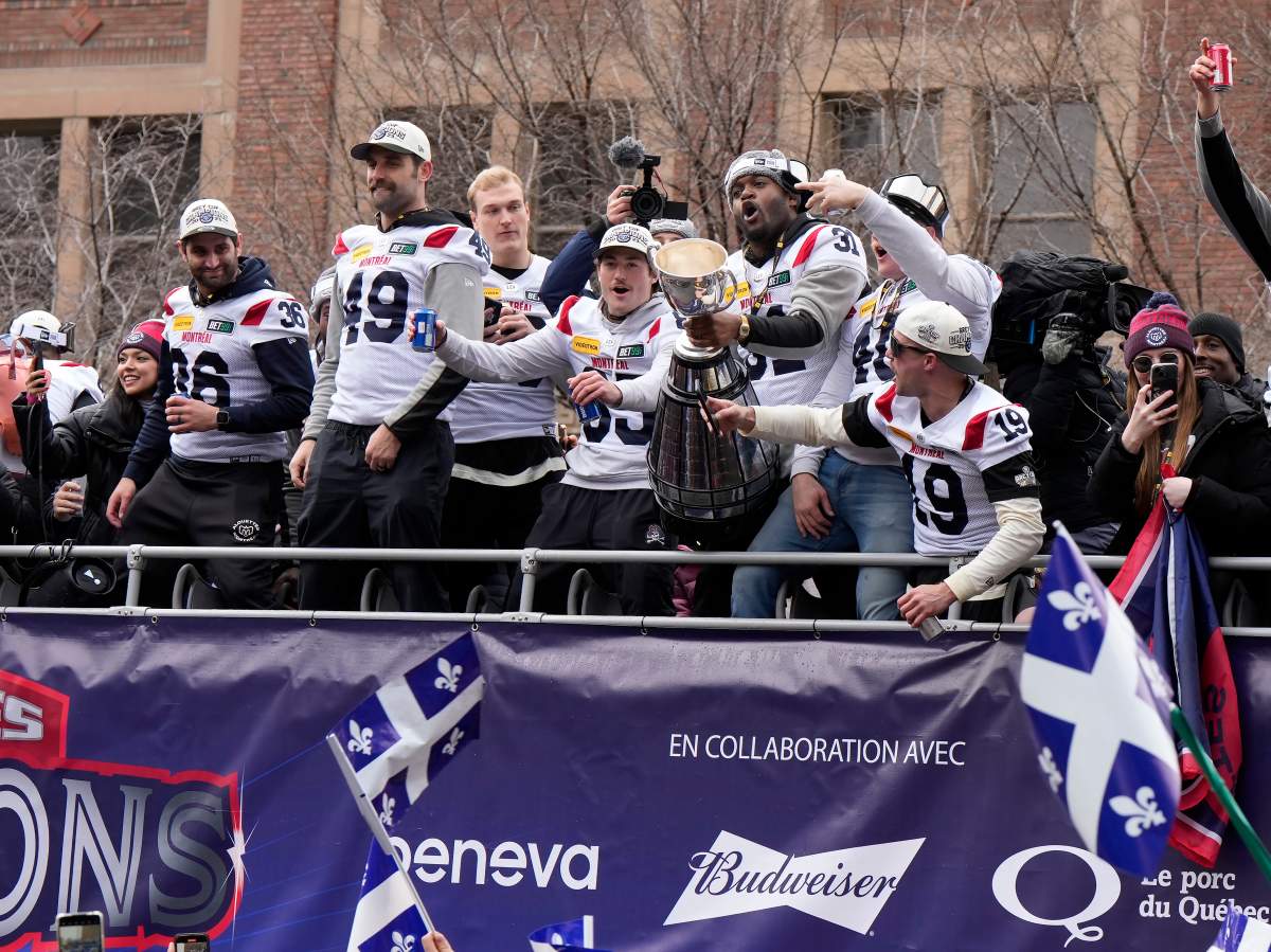 Montreal Alouettes players celebrate during the Grey Cup parade in Montreal on Wednesday, Nov. 22, 2023.