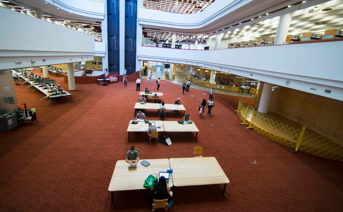 TORONTO, Aug. 24, 2020. People wearing face masks keep a physical distance as they study at a library in Toronto.