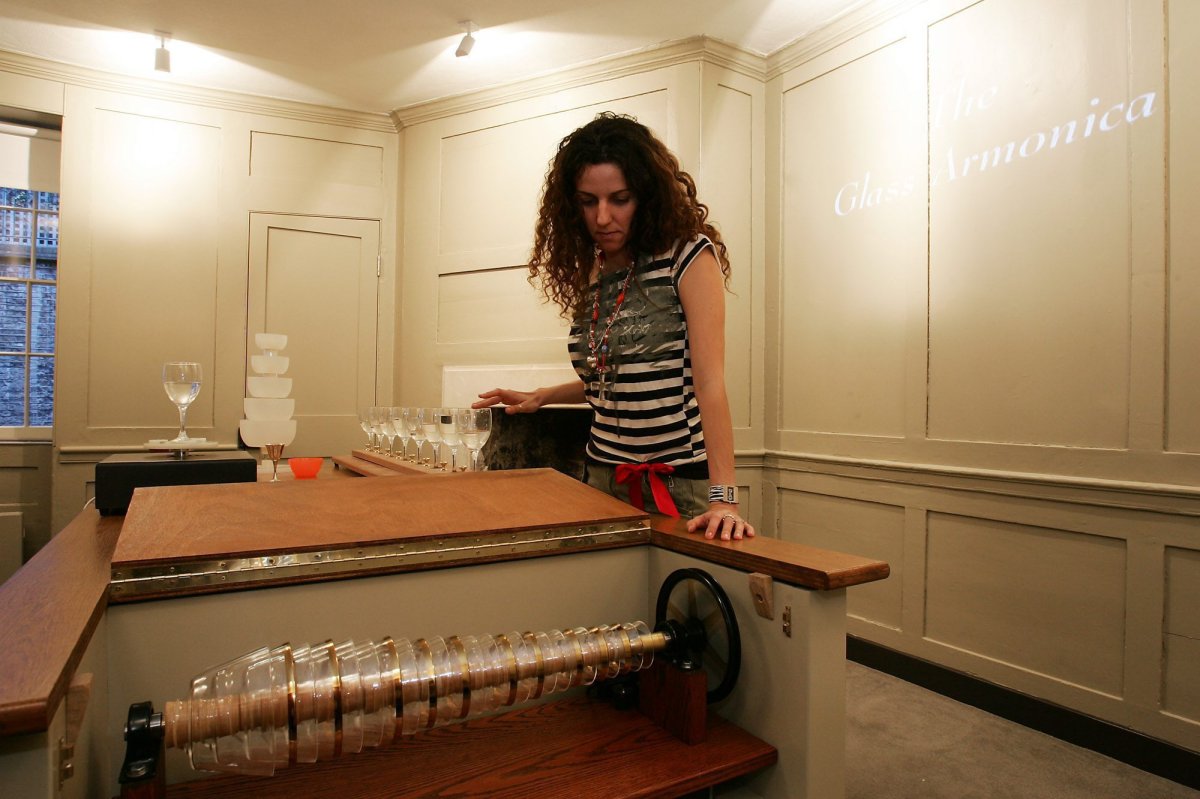 FILE - From Jan. 16, 2006. Anna Doria Buchan, Benjamin Franklin museum education officer, checks the glass armonica in the demonstration room in Franklin's house in London, England. Franklin invented the armonica, an ethereal-sounding musical instrument, in the home.