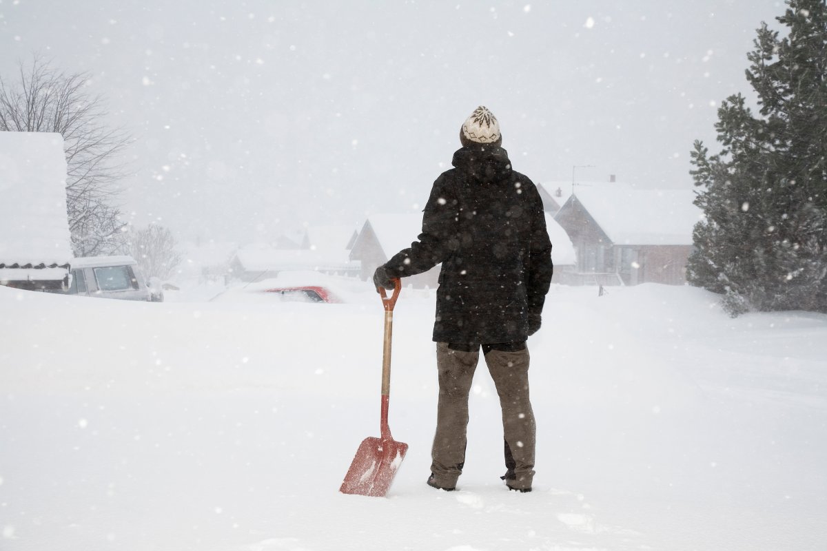 Man holding shovel in the snow