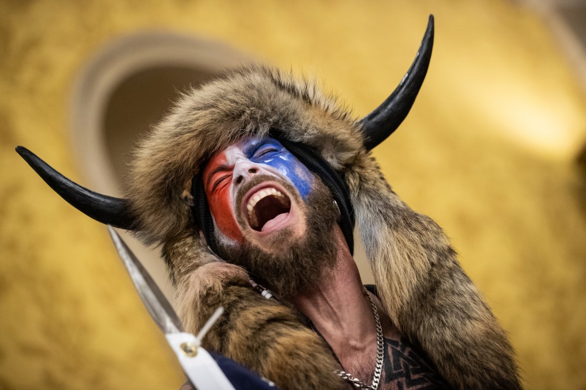 Jacob Chansley, also known as the 'QAnon Shaman,' screams 'Freedom' inside the U.S. Senate chamber after the U.S. Capitol was breached by a mob during a joint session of Congress on Jan. 6, 2021 in Washington, D.C.