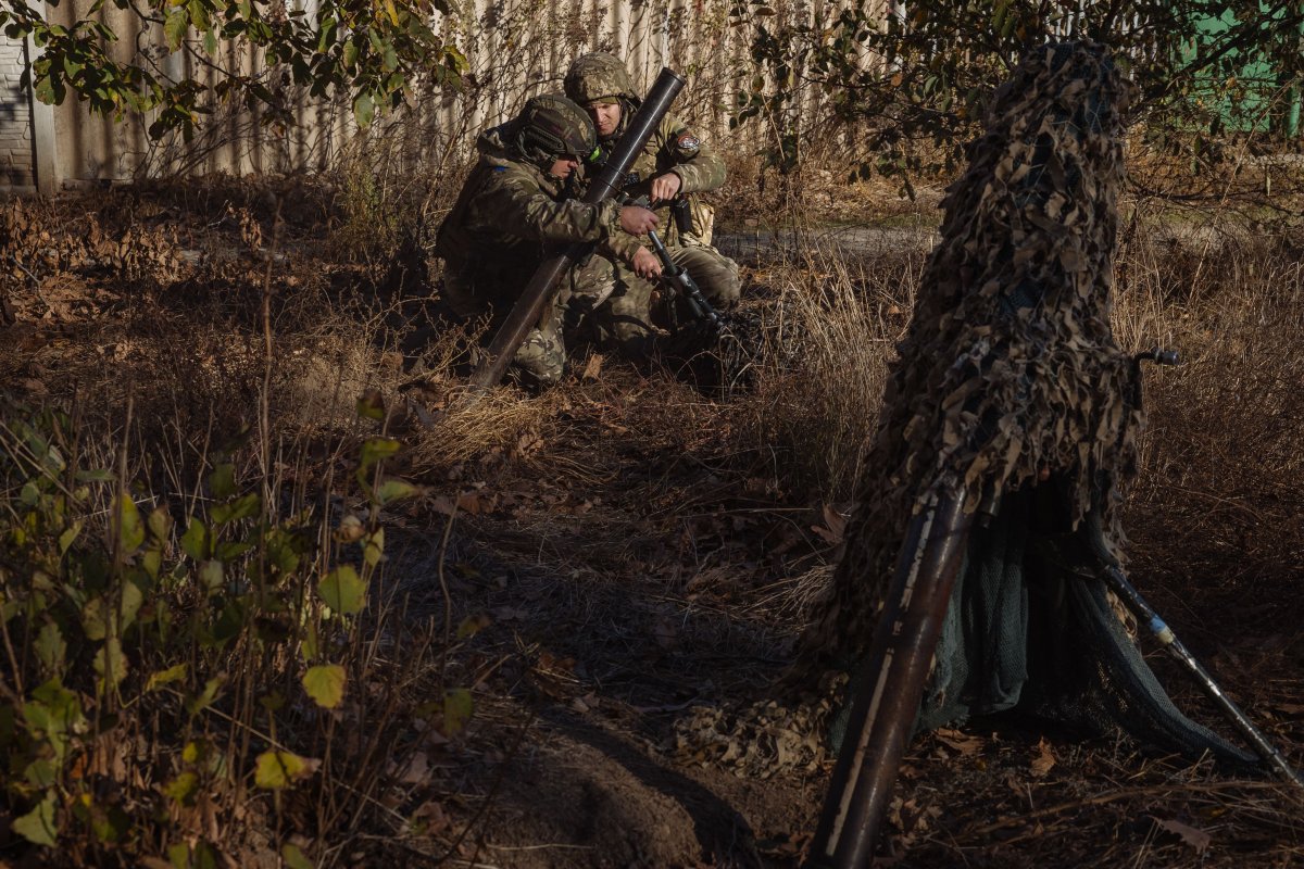 Ukrainian servicemen of the 123rd Territorial Defence Brigade prepare to fire a mortar over the Dnipro River toward Russian positions, in an undisclosed location in the Kherson region, on Nov. 6, 2023.