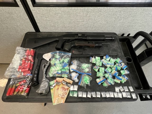 RCMP in Dauphin, Man., say they have arrested a previously wanted man and seized firearms, drugs and cash in the process.