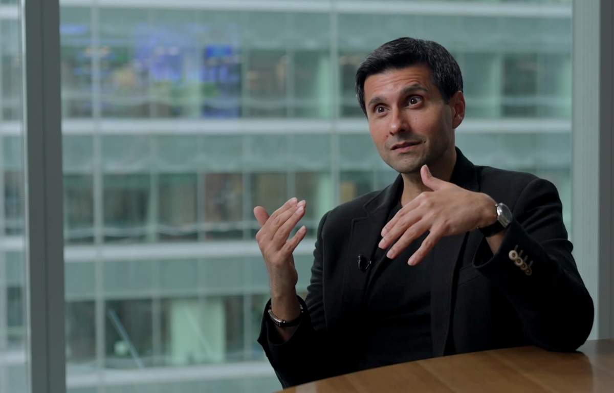 Jas Jaaj is sitting at a table during an interview.