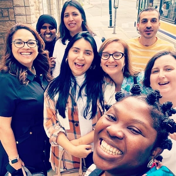 Svitlana Bondarenko smiles with her coworkers at Hamilton's YWCA.