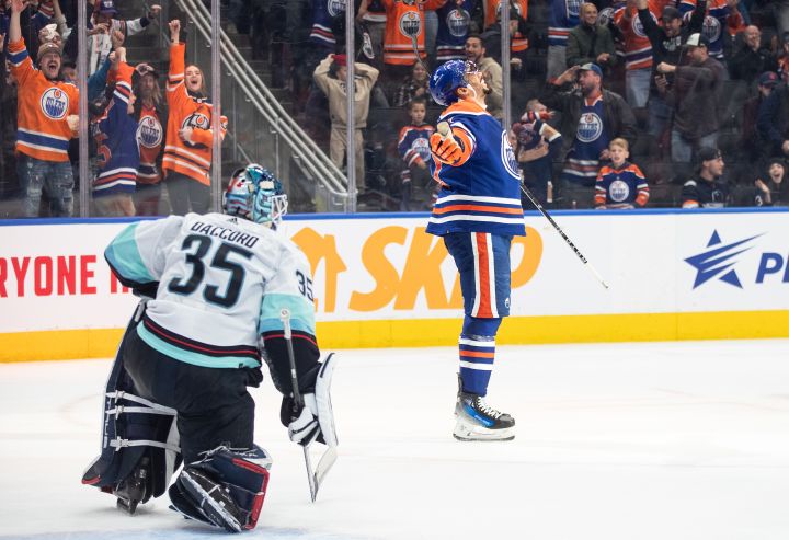 Seattle Kraken goalie Joey Daccord (35) looks on as Edmonton Oilers' Evander Kane (91) celebrates a goal during overtime NHL action in Edmonton on Wednesday November 15, 2023.THE CANADIAN PRESS/Jason Franson