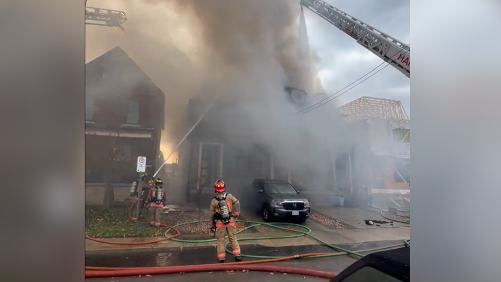 Firefighters battle a blaze in a residential neighbourhood at Melbourne Avenue and Dundurn Street in Hamilton, Ont.  