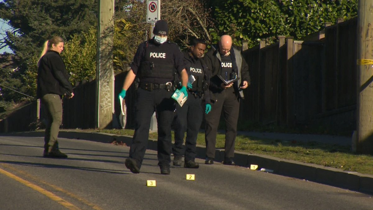 Police were seen placing evidence cones on the road outside at home hit by gunfire in Langley, B.C. on Nov. 25, 2023.