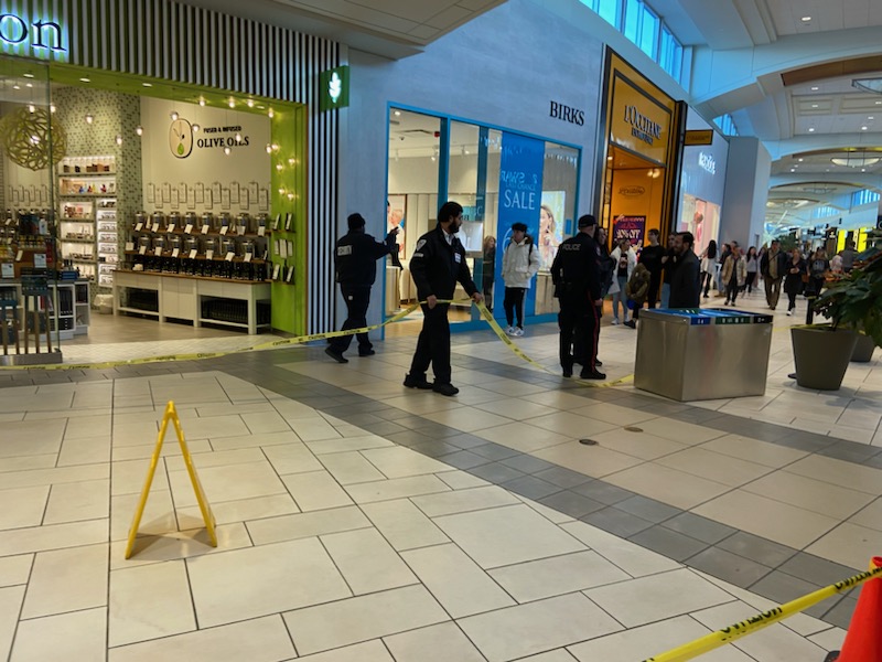 Police and security guards cordon off an area inside Market Mall after an assault with a weapon, on Nov. 24, 2023.