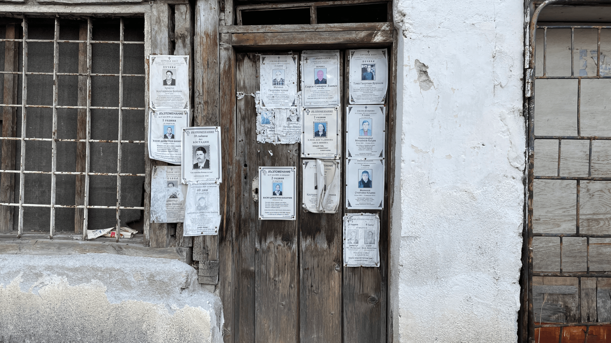 Memorial posters, called necrologs, that honour the memory of the dead are stapled to wooden doors throughout Bansko.