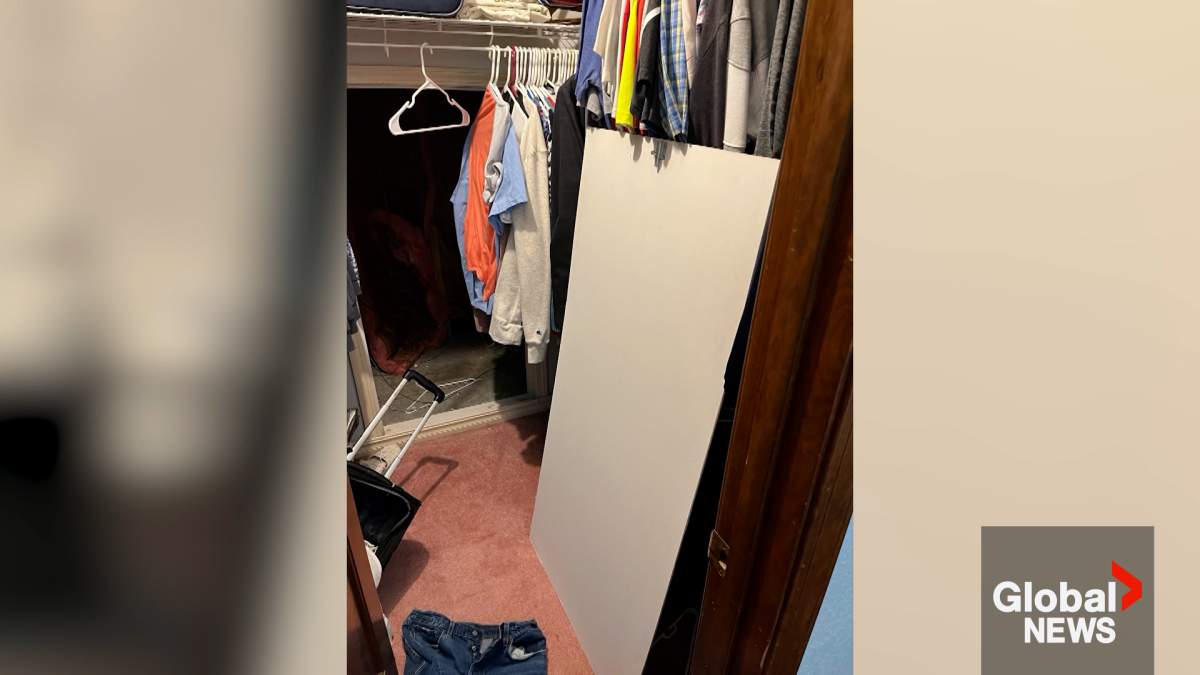 Photo of a whiteboard and a small compartment hidden inside a closet. Tontitown police allege that a man hid his five-year-old daughter in this small opening and nailed it shut with the board.
