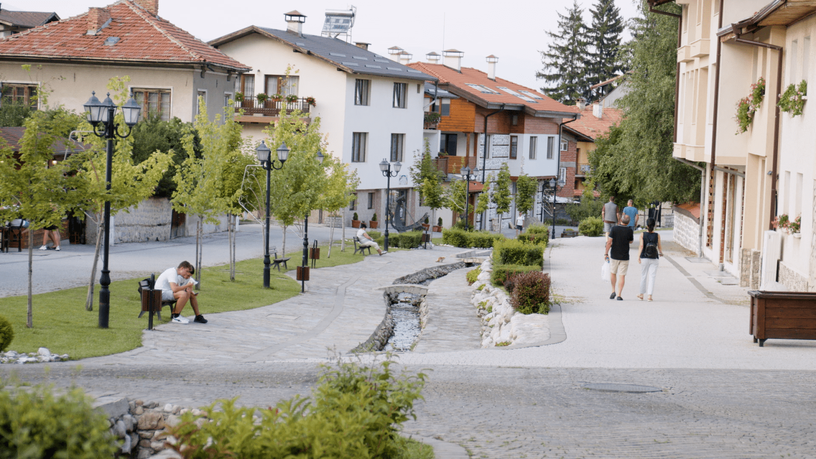 A residential street with a stream running along it in Bansko, Bulgaria.