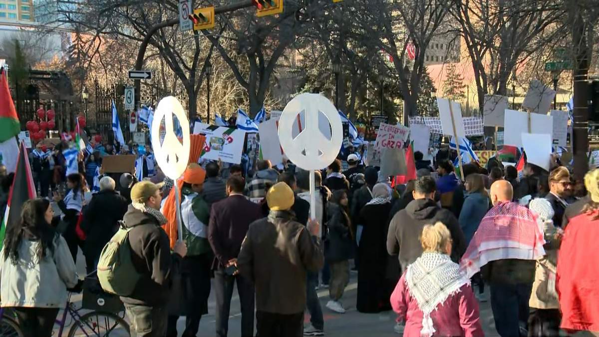 Pro-Israeli and pro-Palestinian protests are pictured outside Calgary City Hall on Nov. 5, 2023. Calgary police have charged one man with causing a disturbance and a hate motivation has been applied after police said the man used an "anti-Semitic phrase."