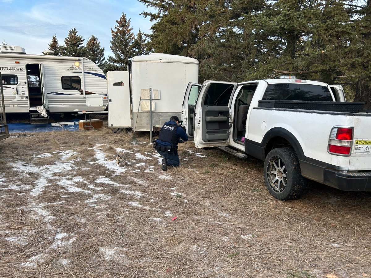 An undated photo of an RCMP investigator documents evidence on a rural property in Wheatland County, as part of an investigation that started with the discovery of a drone that crashed near the Drumheller Institution.