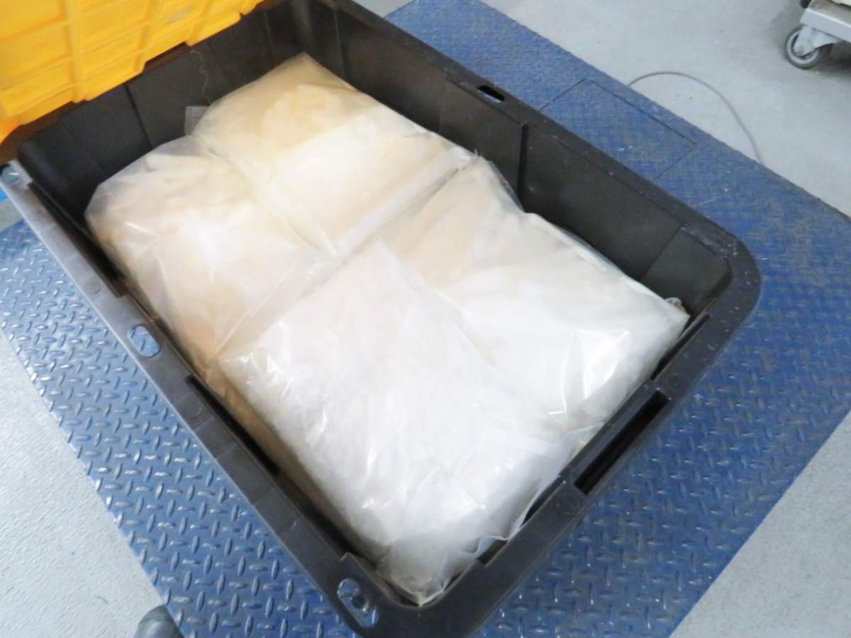 A picture of packages of meth inside of a container.