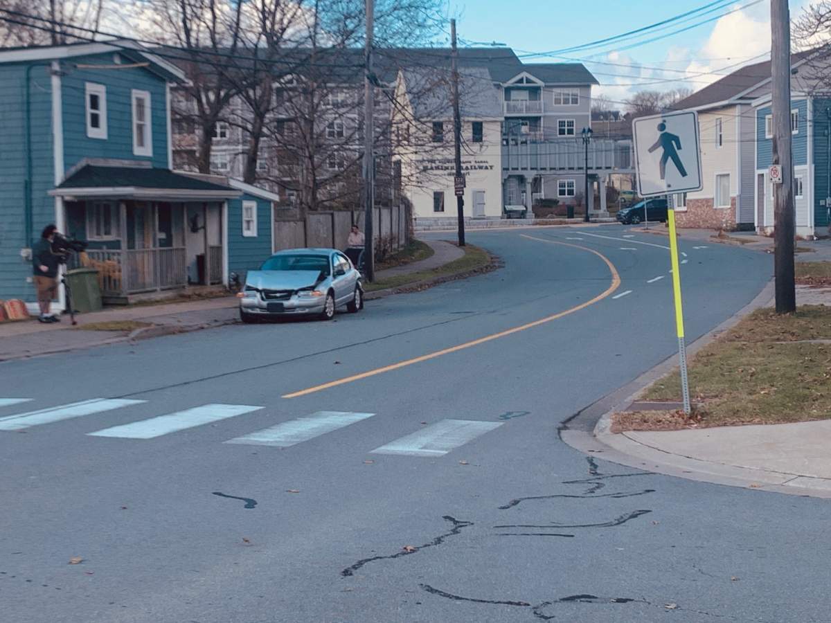 One of the damaged vehicles that was allegedly hit by a stolen front-end loader is seen on Pleasant Street in Dartmouth.