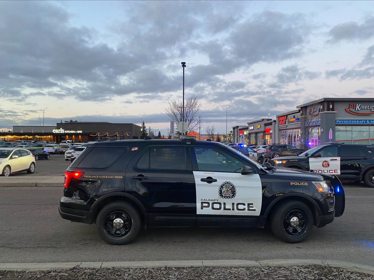 A large number of police officers can be seen outside a restaurant in southeast Calgary after a shooting on Saturday afternoon.