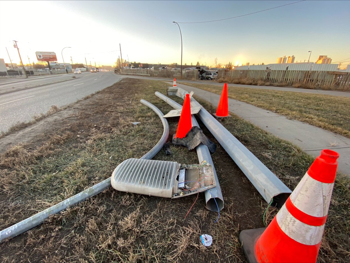 A freshly-fallen light post is pictured in Calgary's Ogden area on Nov. 28, 2023. Police said late on Nov. 27, a sedan struck a light post in the area in part of a single-vehicle collision that killed a man in his 20s.