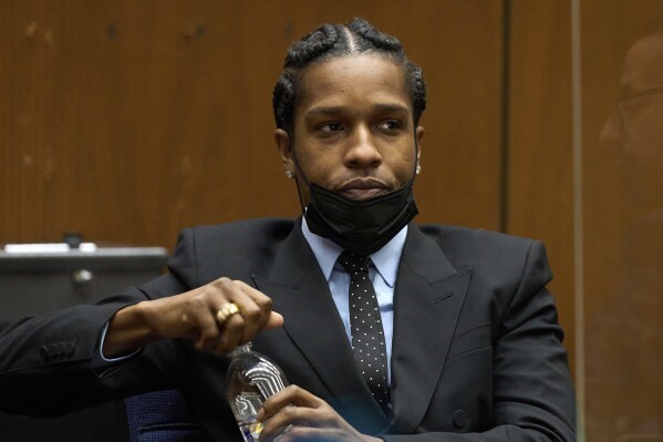 A$AP Rocky in court. He is holding a water bottle.