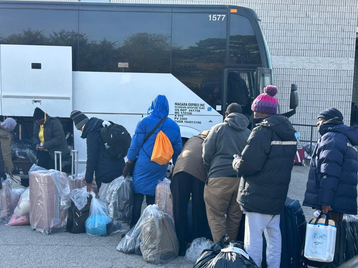 People waiting outside the Mississauga shelter seen boarding a bus on Nov. 16, 2023.
