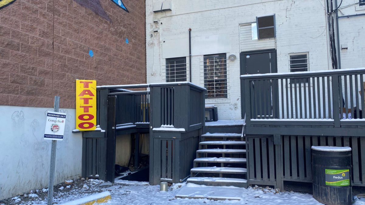 The entrance to PoK Tattoo Shop in the 600 block of 17th Avenue Southwest. Christopher English, seen between the fence boards, is accused of selling drugs out of the business.