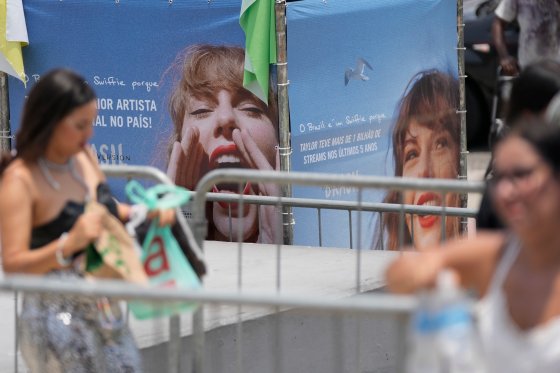 Taylor Swift fans stand outside amid a heat wave.