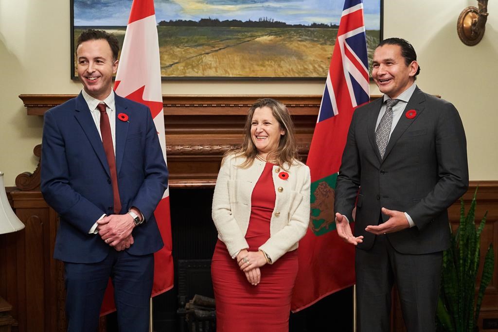 Deputy Prime Minister and Finance Minister Chrystia Freeland, centre, meets with Manitoba Premier Wab Kinew, right, and Manitoba's Minister of Finance Adrien Sala at the Manitoba Legislative Building in Winnipeg on Wednesday, Nov. 8, 2023. The Manitoba government is broadening its plan for a tax holiday on gas and diesel fuel. Sala says the government will amend a bill now before the legislature that will suspend the 14-cent-a-litre fuel tax for at least six months, starting Jan. 1.