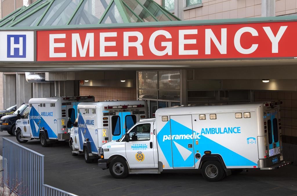 A 14-year-old girl is in the hospital after being struck by a TTC bus, emergency officials say. A paramedic closes the doors of an ambulance at a hospital in Toronto on Tuesday, April 6, 2021. 