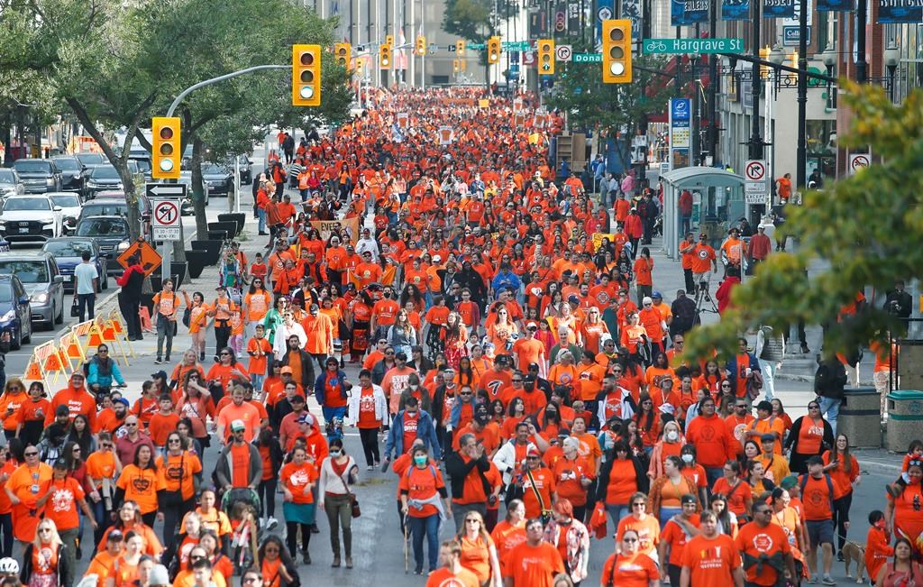 People attend the second annual Orange Shirt Day Survivors Walk in Winnipeg on Sept. 30, 2022.